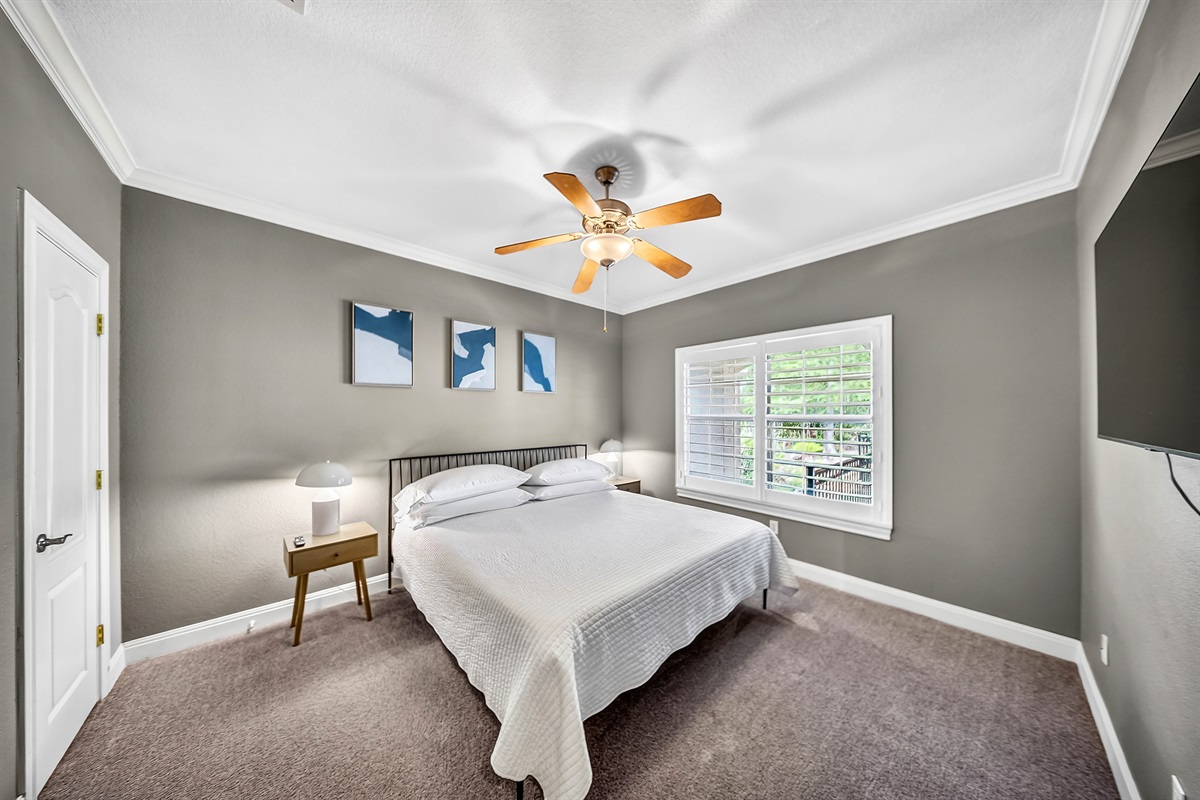 Downstairs king bedroom with a comfortable mattress, 42 inch TV, and dedicated clothing storage. Easy access and a relaxed, quiet space for guests who prefer to stay on the main level.