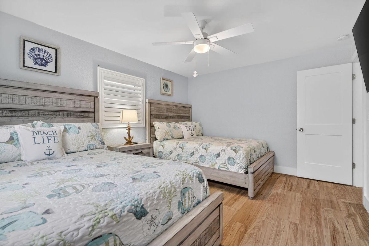 Bedroom with beach-themed bedspread, second view