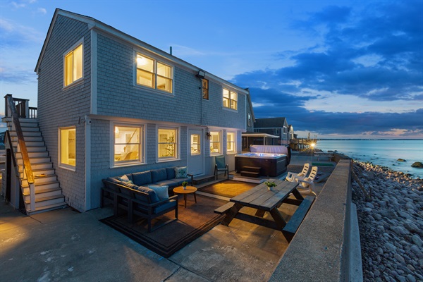 Welcome to our serene outdoor sitting area, where the gentle ocean breeze and the warmth of the hot tub create the perfect atmosphere for unwinding!