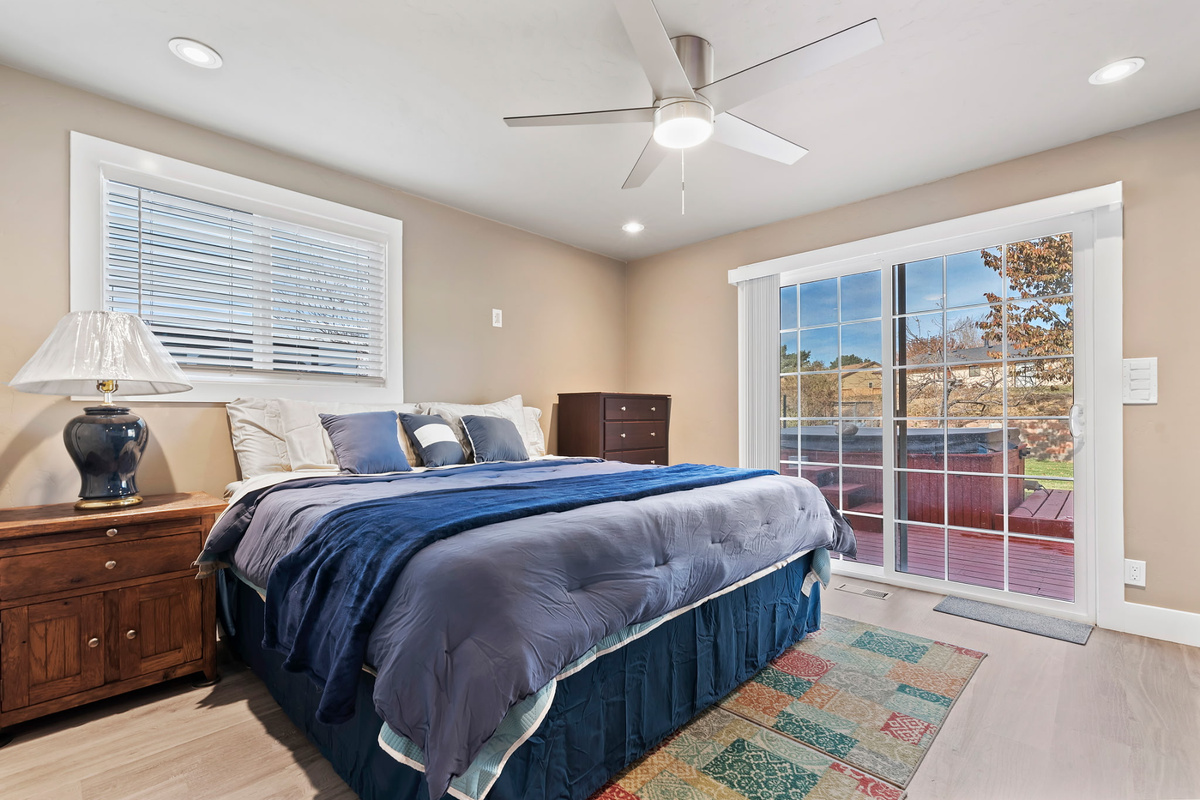 Spacious primary bedroom featuring private access to the back patio and a Smart TV for your comfort and entertainment.