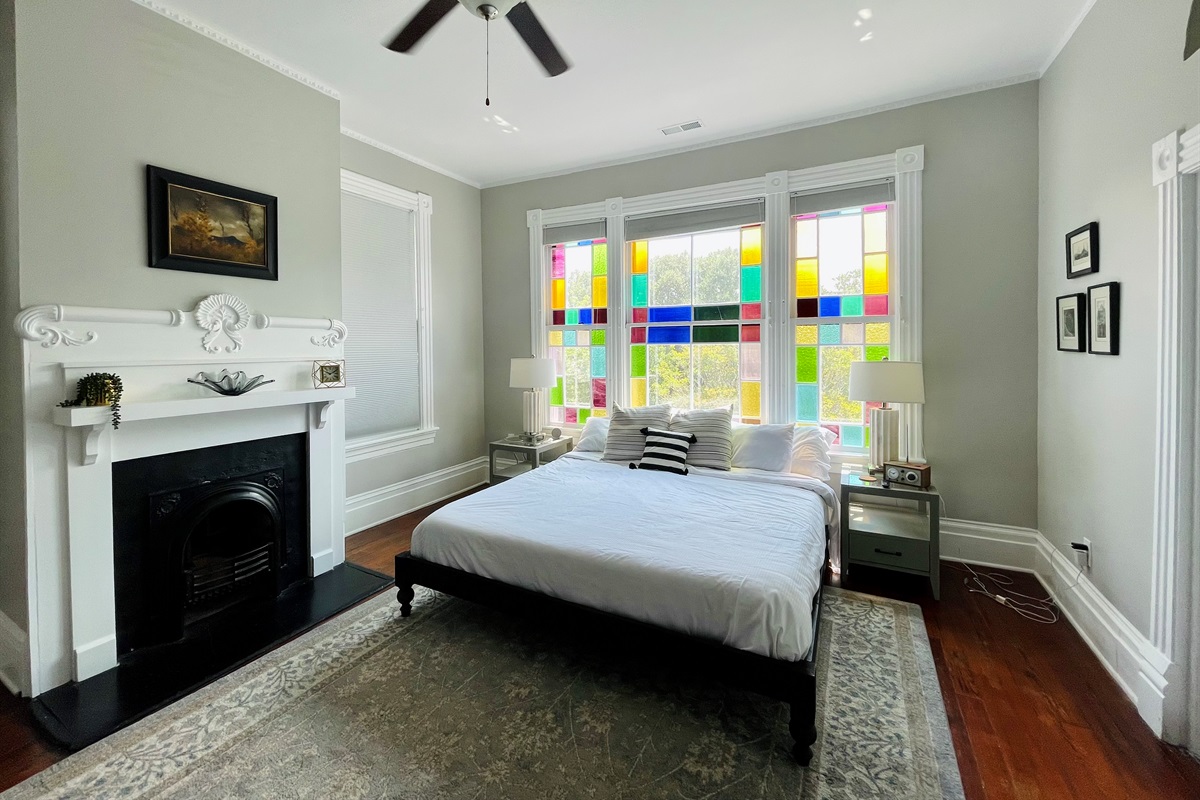 Primary bedroom with ensuite bath is truly a gem.  Stretch out on the king sized bed, enjoying the Savannah sunshine shining through the stain glass windows.  Located on one of the quieter blo