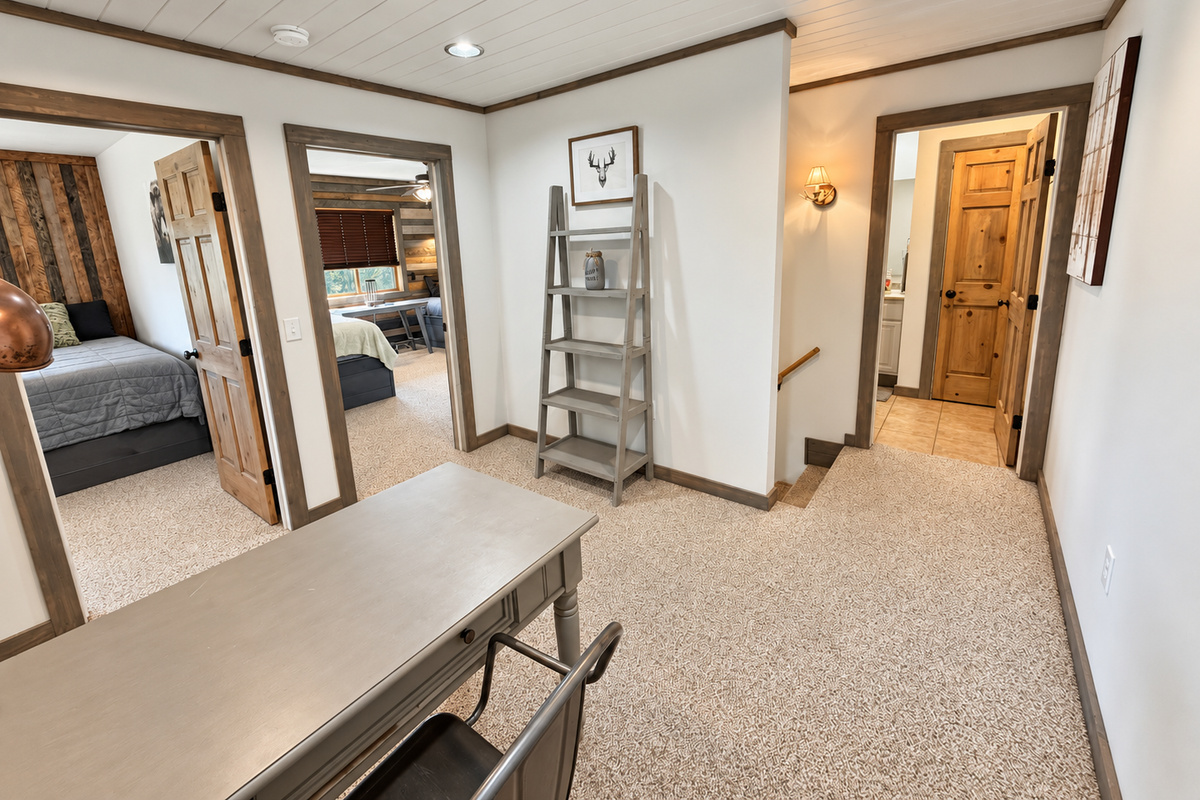 At the top of the stairs, the full bathroom is conveniently positioned near all three upper-level bedrooms, making the layout easy and comfortable for families and groups.