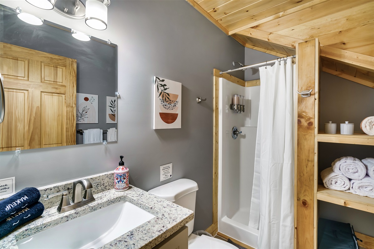 Our spacious upstairs bathroom is also storage for our extra towels, q-tips, cotton rounds and even the pack n' play for our littlest guests. 