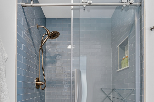 Enjoy a spacious walk-in shower with contemporary design and finishes.
