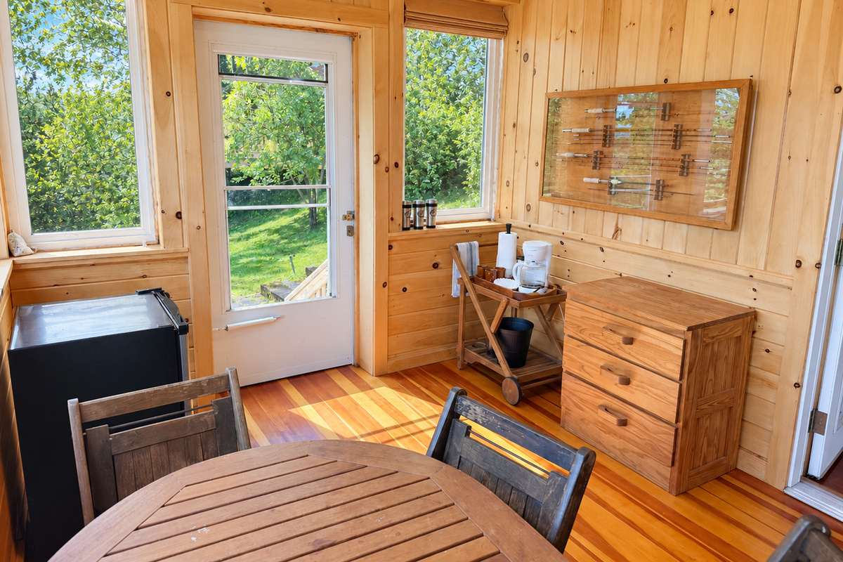 Dining area on sleeping porch with mini fridge and coffee station