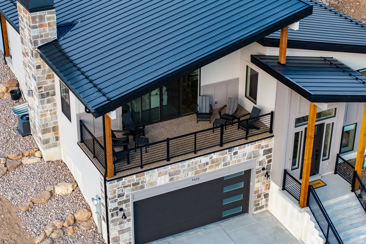 Enjoy fresh mountain air from the covered deck with Adirondack-style seating for six.