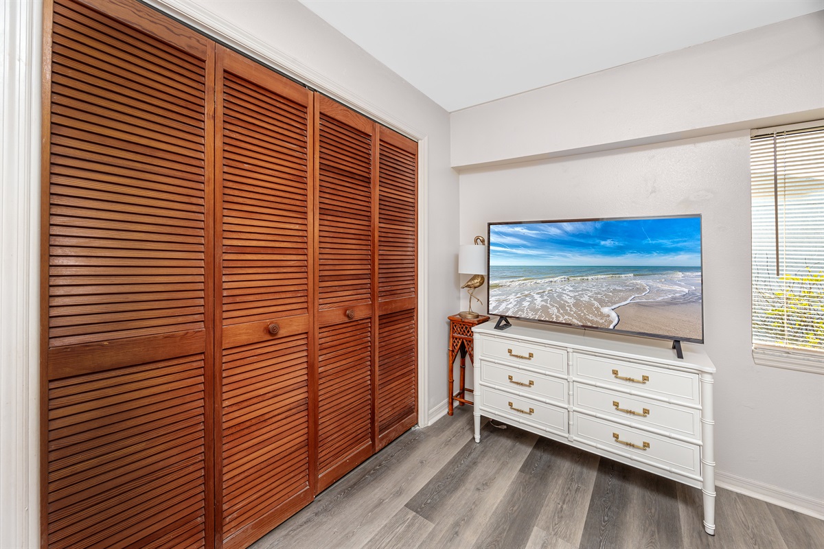 Closet space in Bedroom 2 with a Smart TV