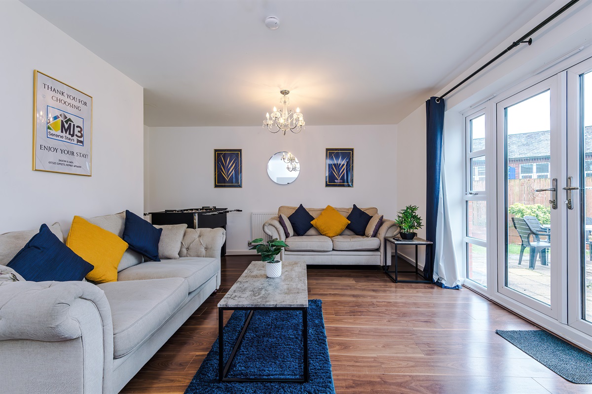 The spacious, bright and vibrant lounge benefits from a comfortable atmosphere and decor leading to the large rear garden via the French doors