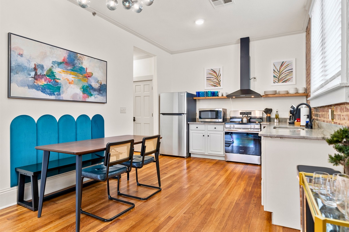 The open layout of the dining and kitchen areas offers a practical and stylish setting for cooking and dining.