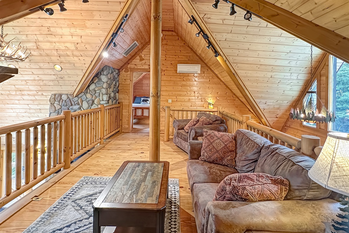 Loft Living Room: Relax in this charming retreat with stunning timber accents and serene views!
