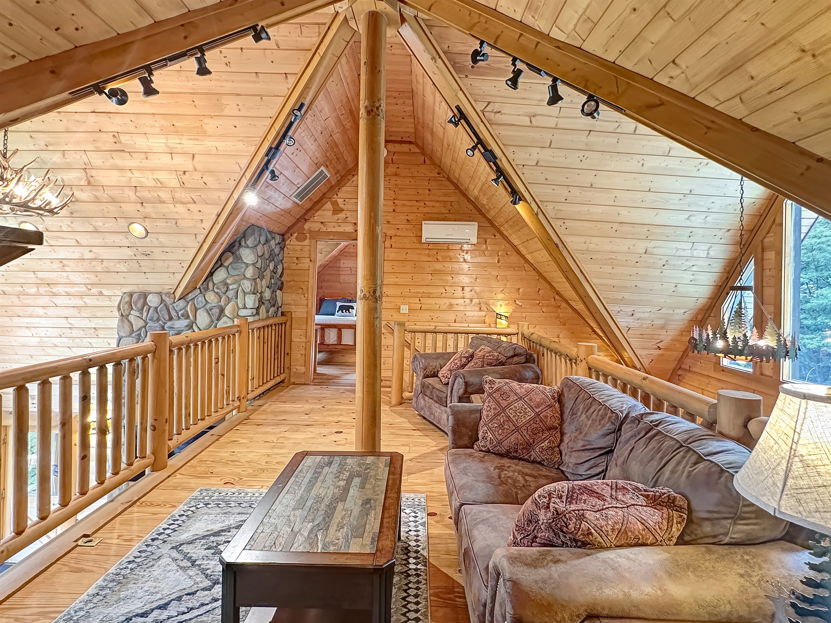 Loft Living Room: Relax in this charming retreat with stunning timber accents and serene views!