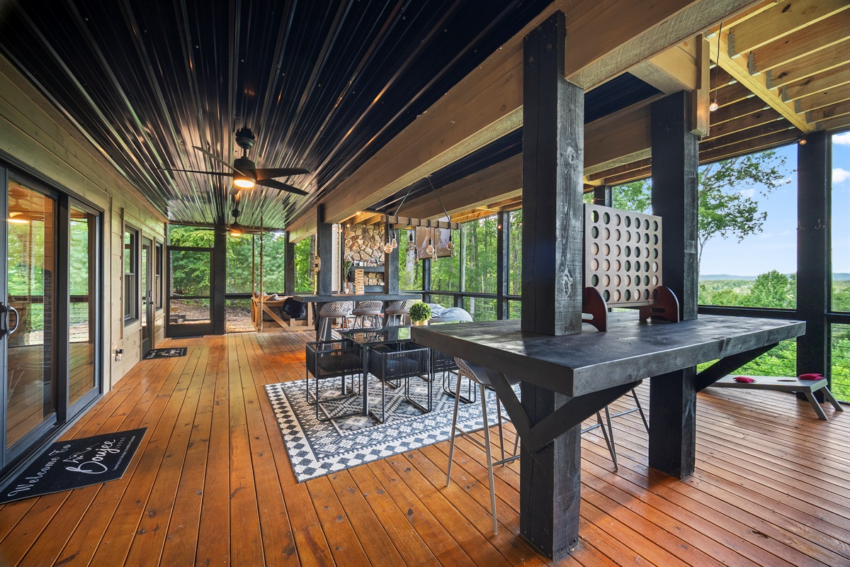 Besides, the spacious deck area offers the perfect blend of outdoor games, casual seating, and stunning views.