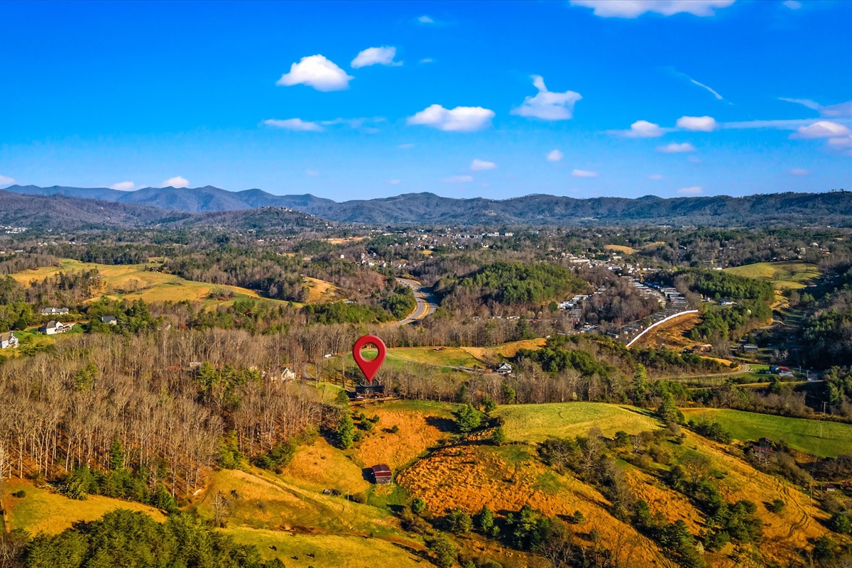 {Aerial View + Location}
Nestled in the Blue Ridge Mountains on 2 private acres bordering farmland — offering privacy, panoramic views, while still 15 minutes to downtown Asheville.