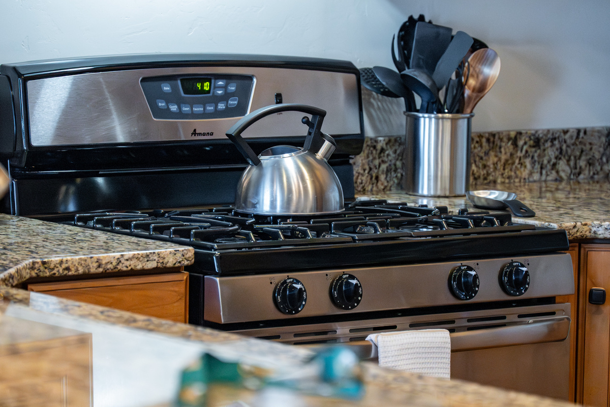 Gas range and modern appliances make meal preparation easy and enjoyable.