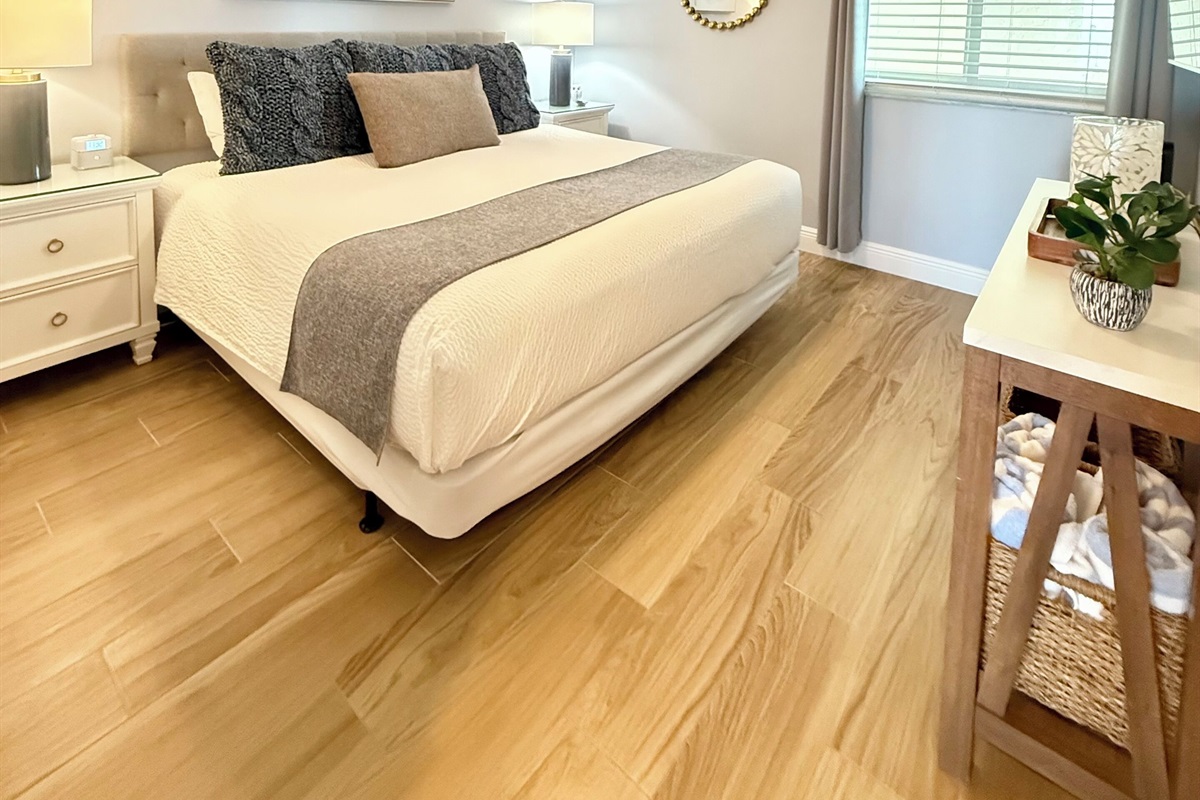 King bed and a 55” flat screen Smart TV mounted on wall