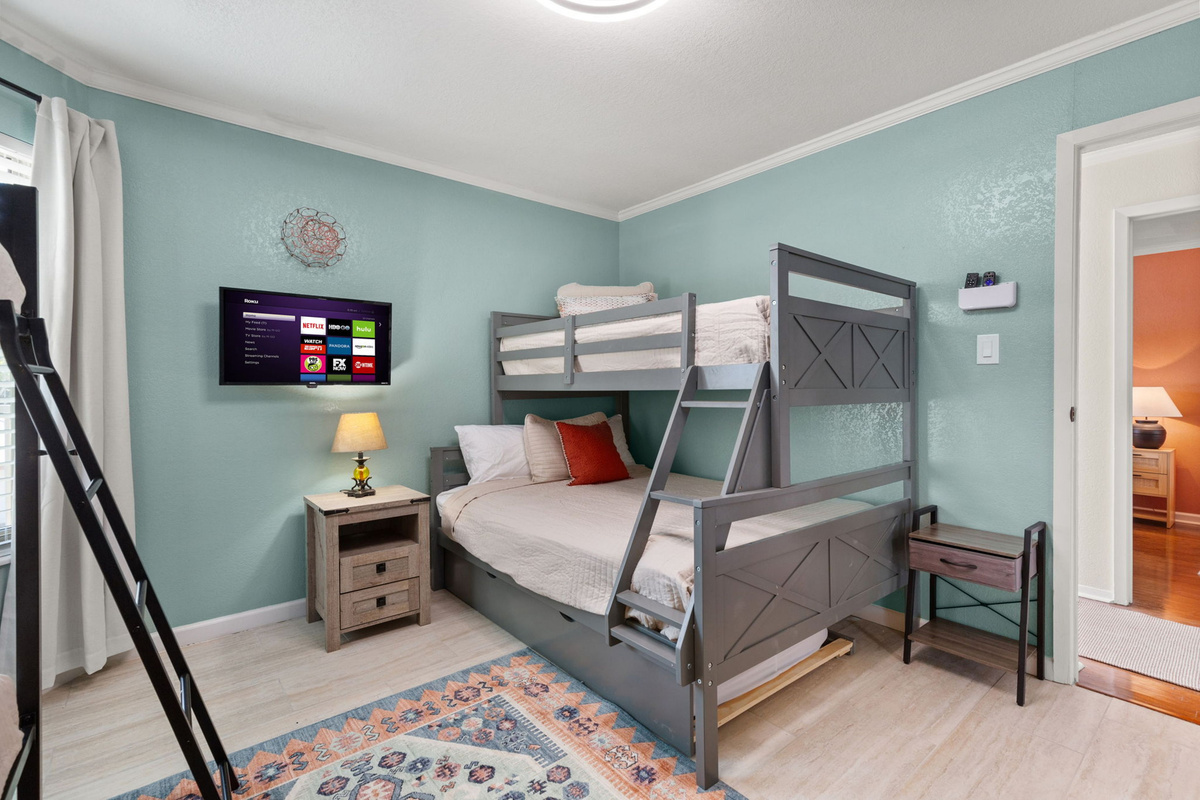 Guest bedroom with flat screen TV.