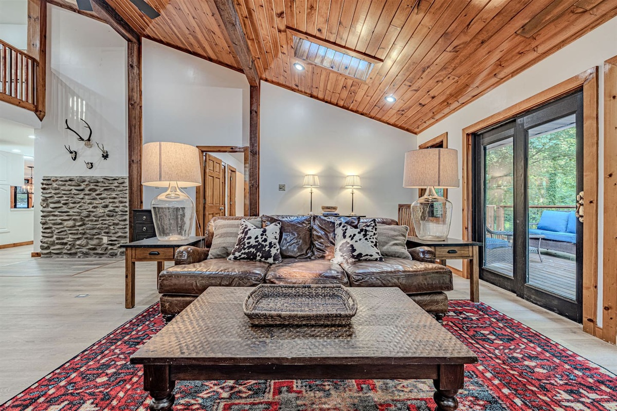 Sink into plush seating beneath soaring cathedral ceilings, where rustic textures and refined comforts come together in a space designed for true relaxation.