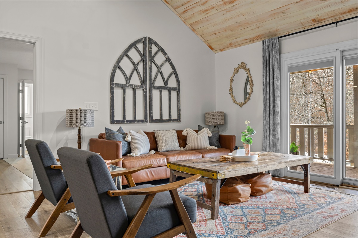 Main living room with view of outdoor balcony.