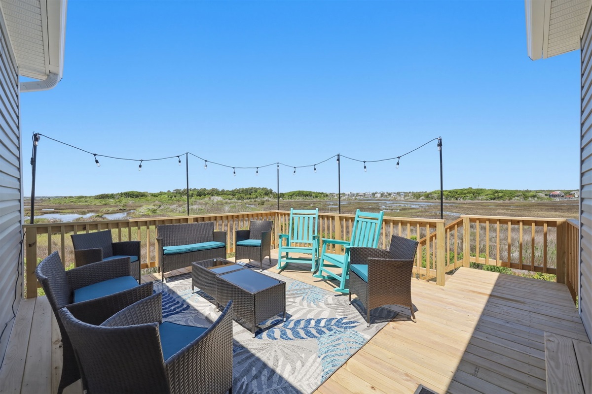 Spacious back deck with lounge seating&mdash;ideal for evening hangouts and coastal breezes