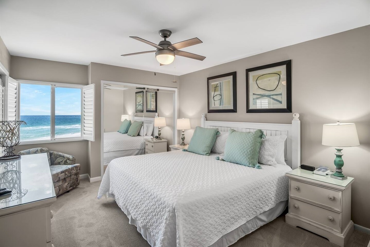 This stylish master bedroom boasts Gulf views, a King bed, balcony access, and a private bathroom