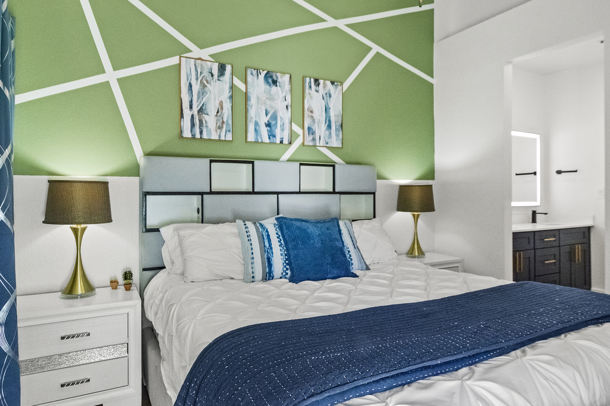 Another calming bed space for guests that features a Roku Smart TV, windows, and a comfortable hybrid mattress. 