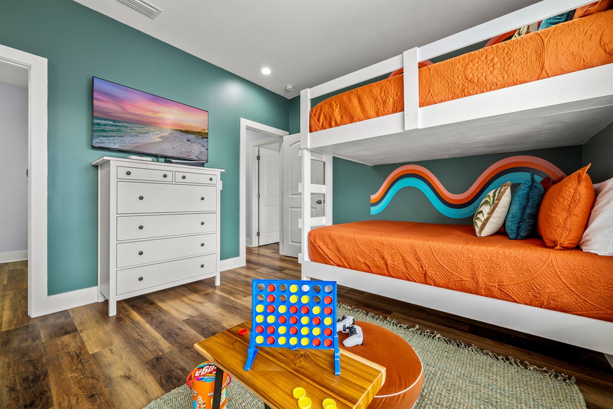 Colorful bunks, games, and plenty of space for movie nights and friendly competitions. The kids may never want to leave this room.