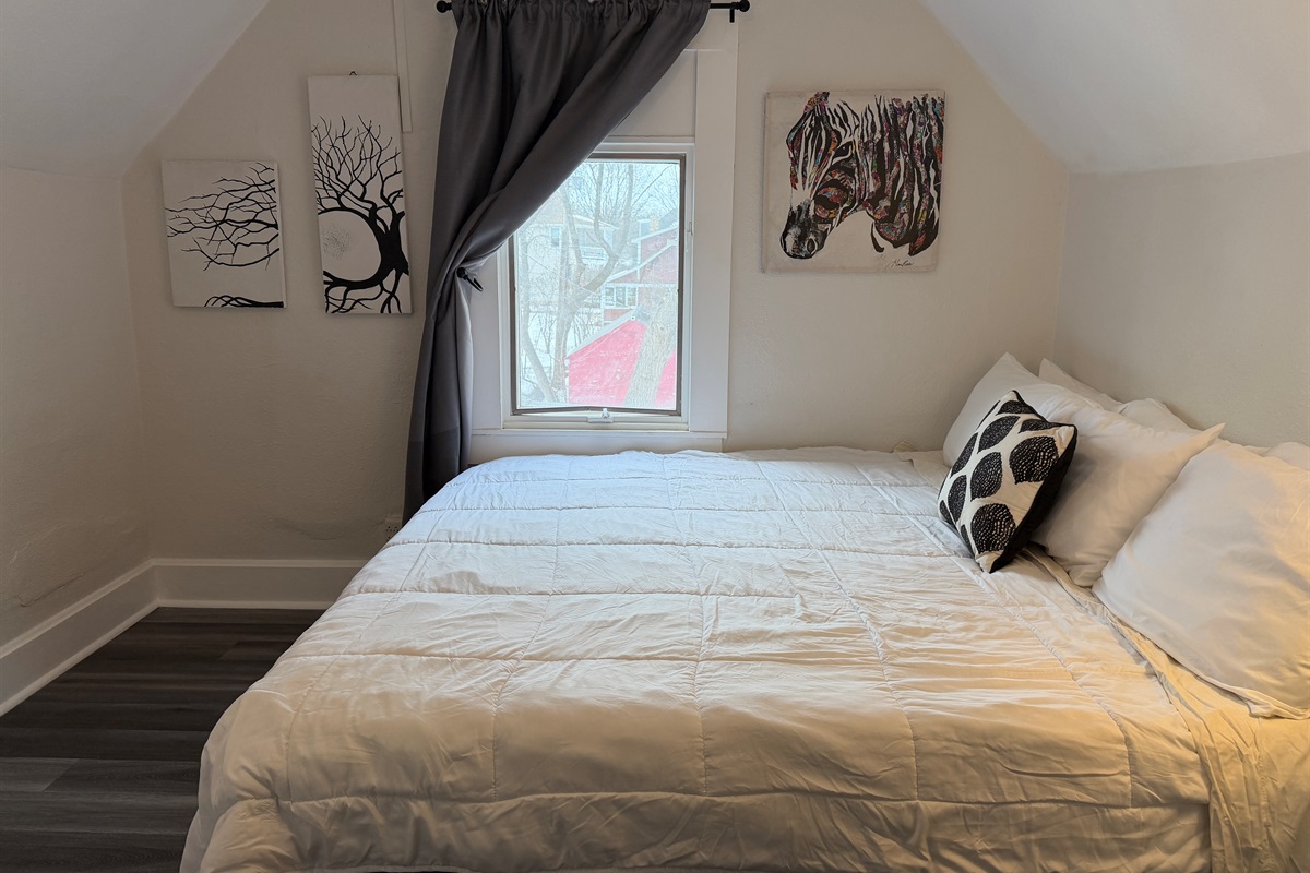 The upstairs king bedroom overlooks the backyard.
