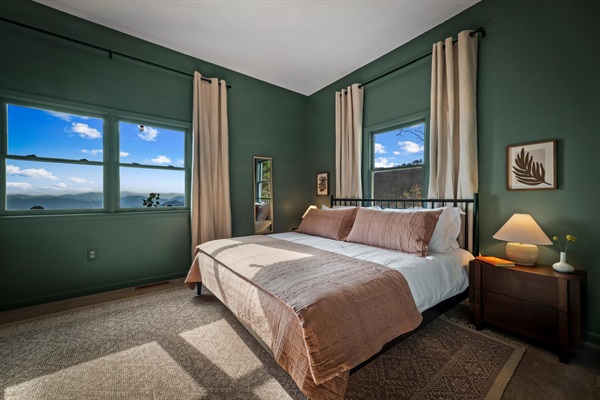 Spacious king bedroom with mountain views and a smart TV—designed for comfort, quiet, and a restful night’s sleep.