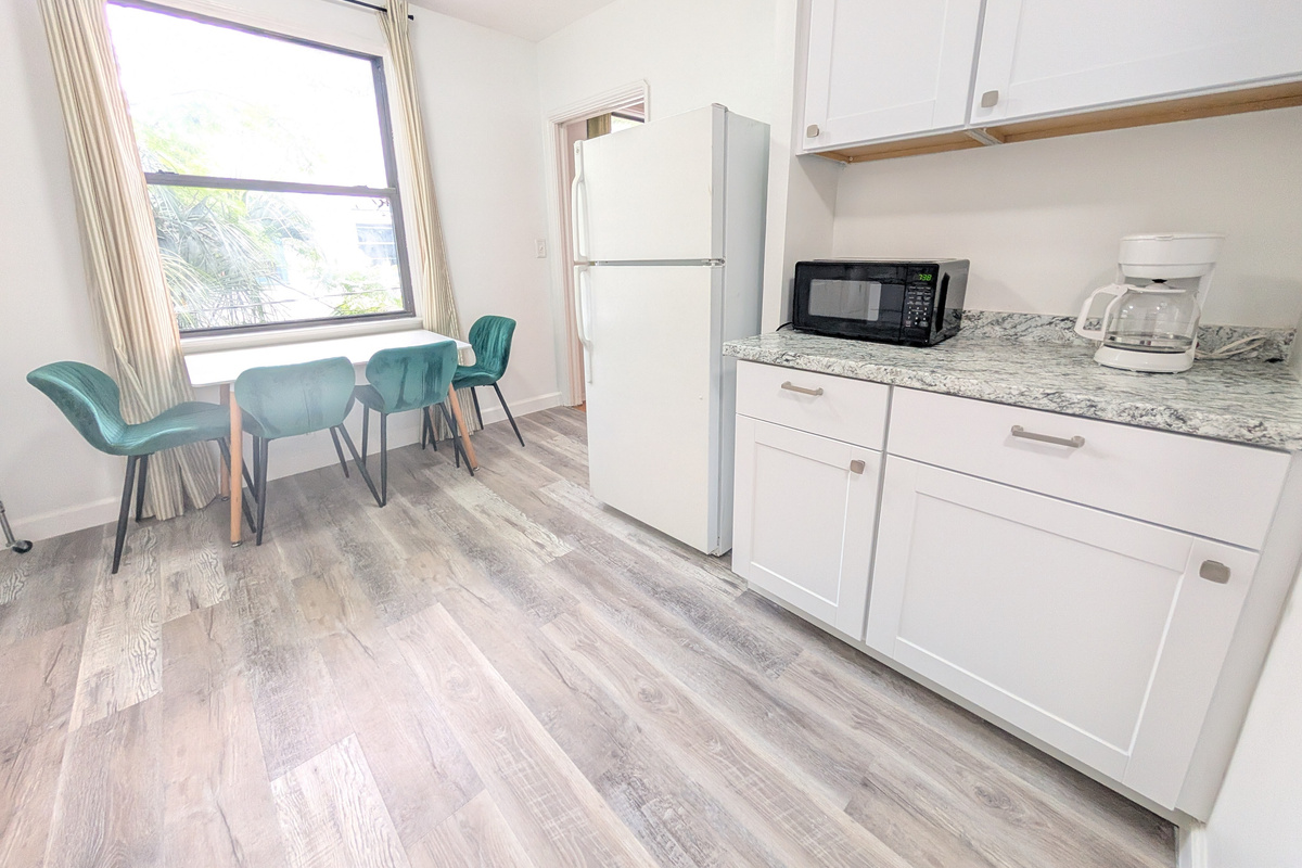Full kitchen with refrigerator and microwave