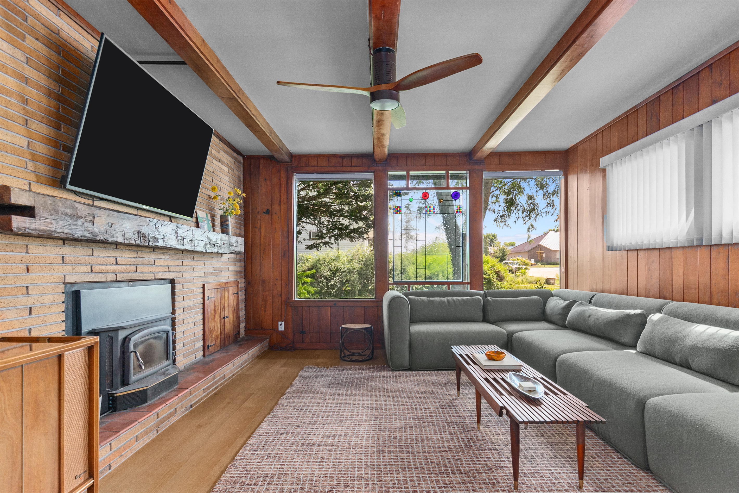 The living room offers a cozy wood-burning fireplace, perfect for gathering together on cool evenings and creating a warm, inviting atmosphere.