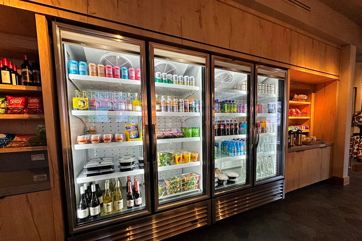 The cold case is stocked with fresh fruit, salads, juices, sodas, beer, wine, and other grab-and-go options—perfect for stocking up between outings.