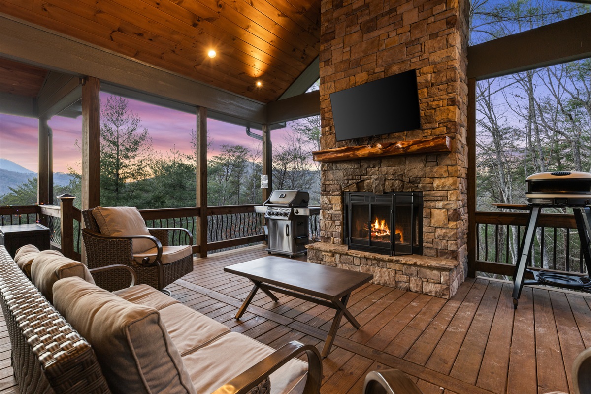 Cozy up by the outdoor fireplace on the party porch, a perfect spot for crisp evenings.