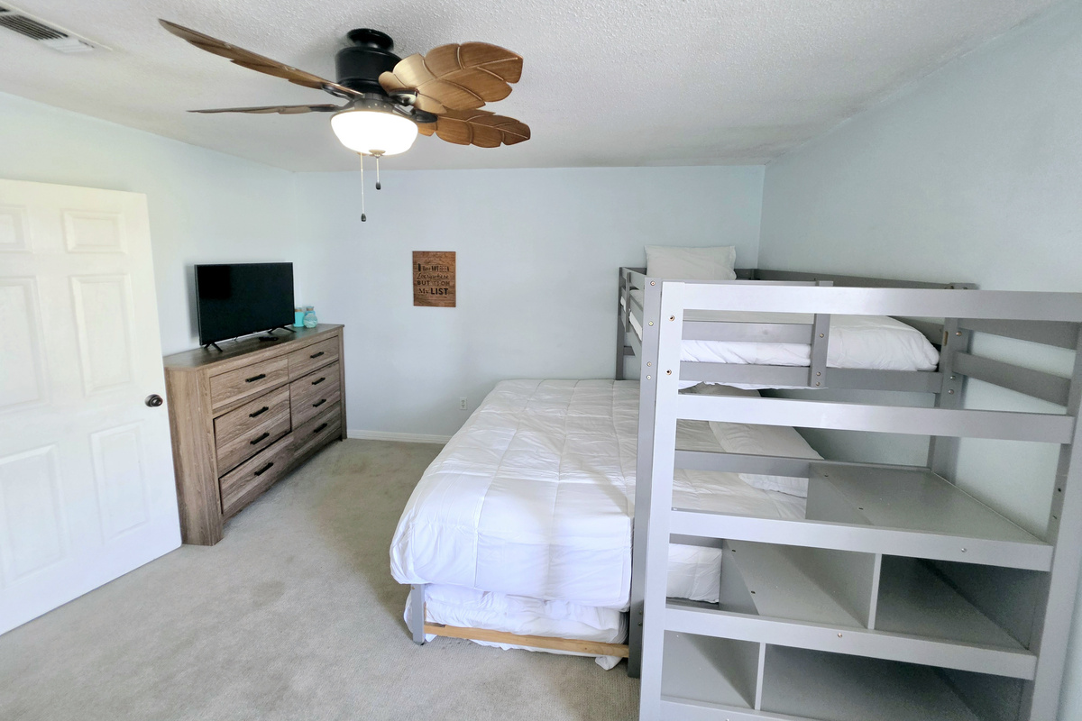 Bunk room with TV and dresser