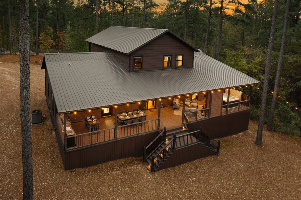 A peaceful woodland retreat wrapped in warm glow. Pinewood Lodge welcomes you with privacy, comfort, and a design forward experience from the very first look.