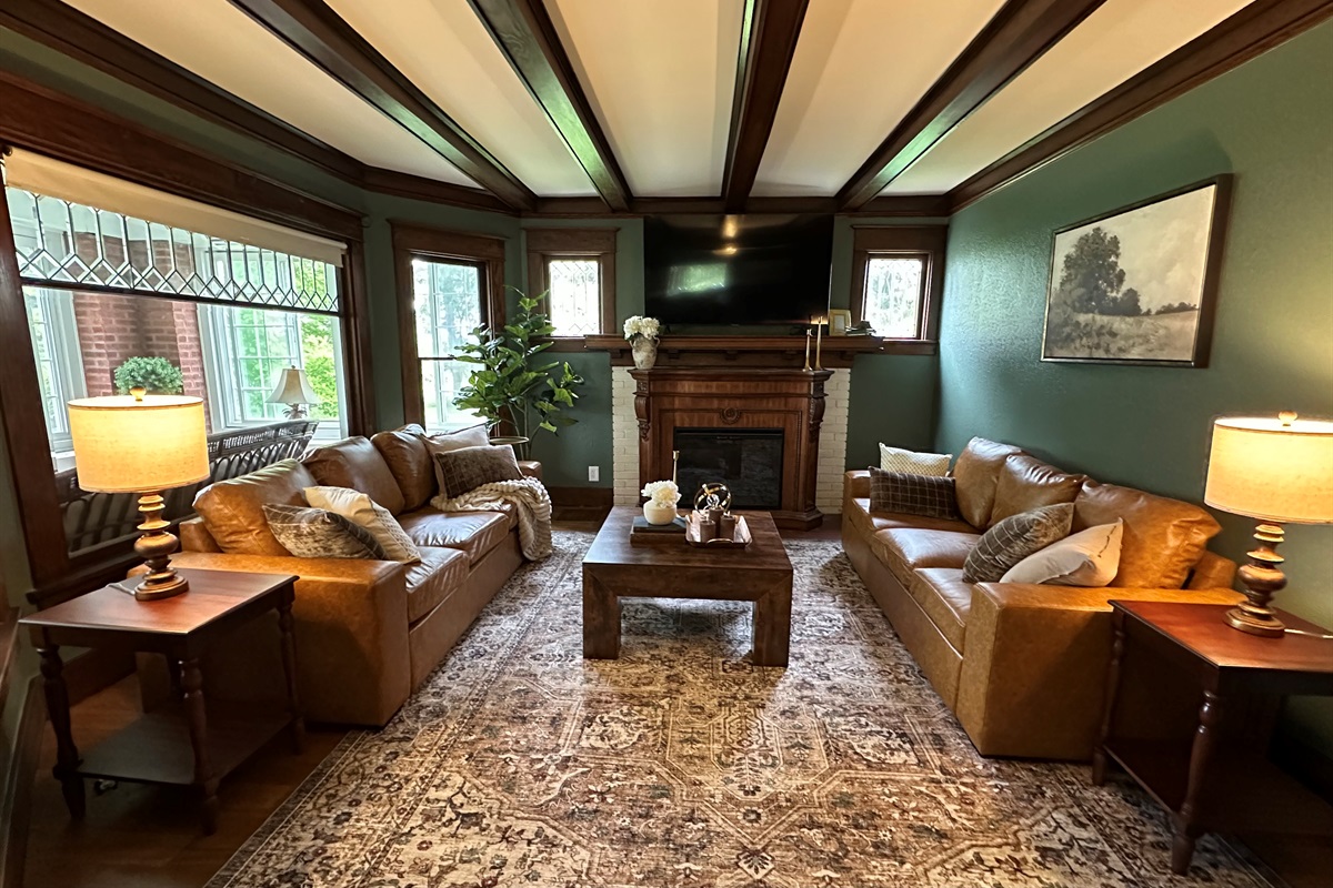 Gather beneath rich wood beams and cozy heritage inspired details in this warm, inviting living room designed for connection and relaxation. Unwind after a great day in a space that feels equal parts timeless and luxurious.