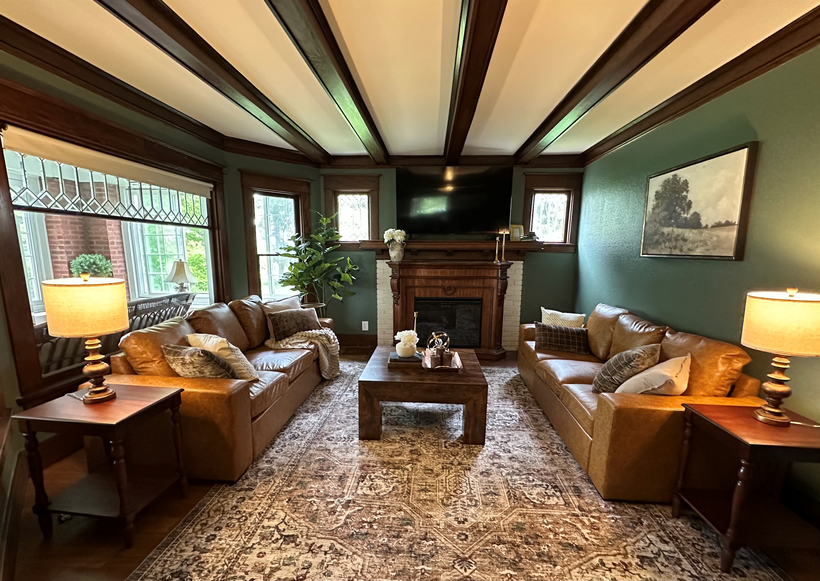 Gather beneath rich wood beams and cozy heritage inspired details in this warm, inviting living room designed for connection and relaxation. Unwind after a great day in a space that feels equal parts timeless and luxurious.