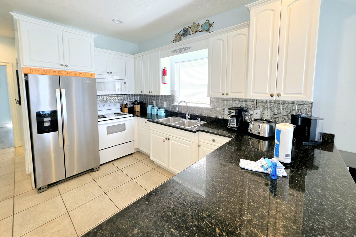 Kitchen with range, microwave and coffee maker