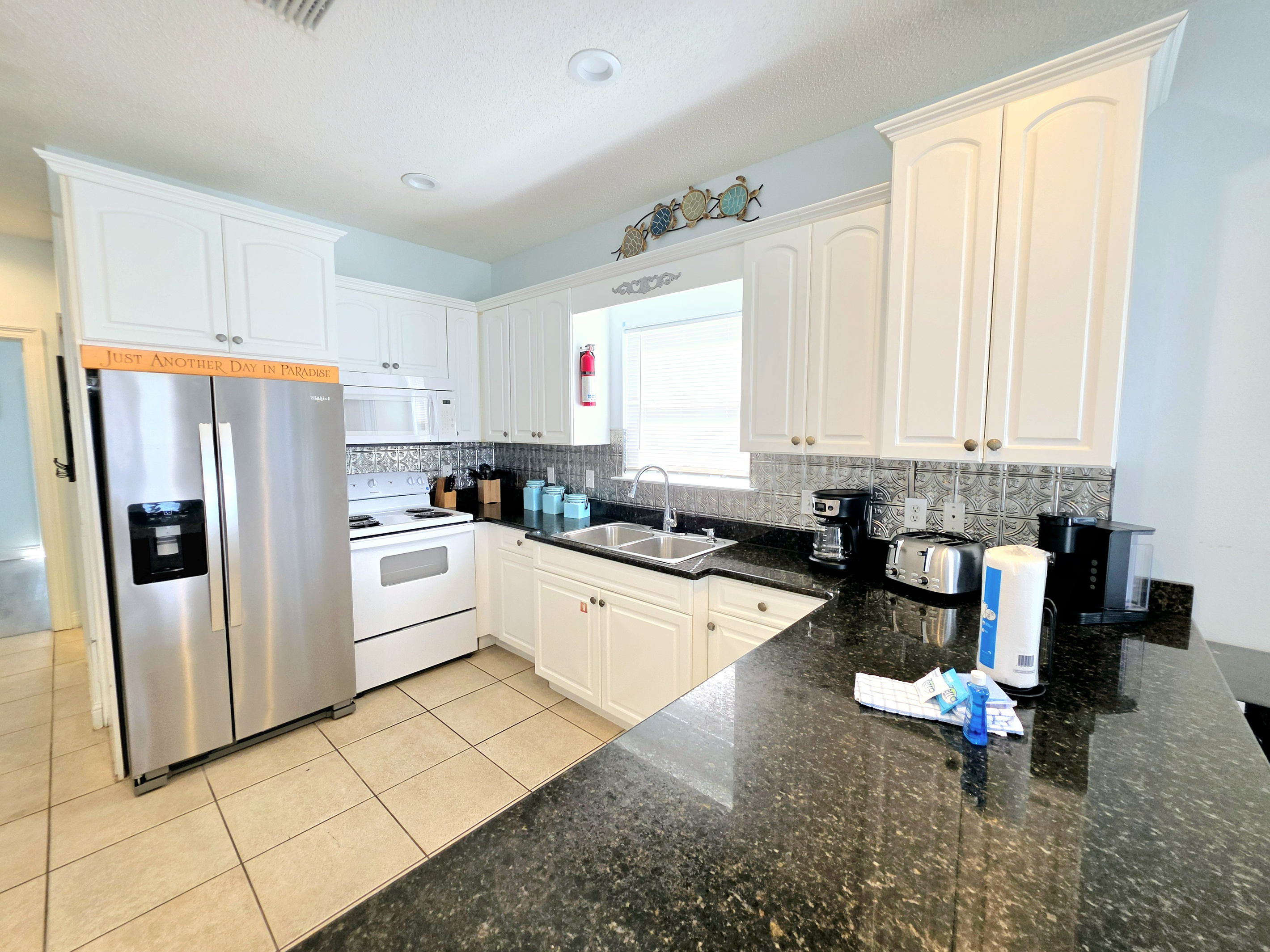 Kitchen with range, microwave and coffee maker