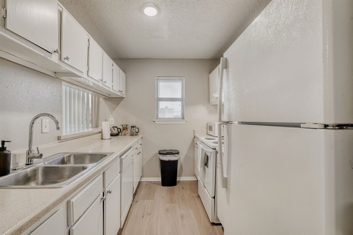 Bright and spotless kitchen with full amenities.