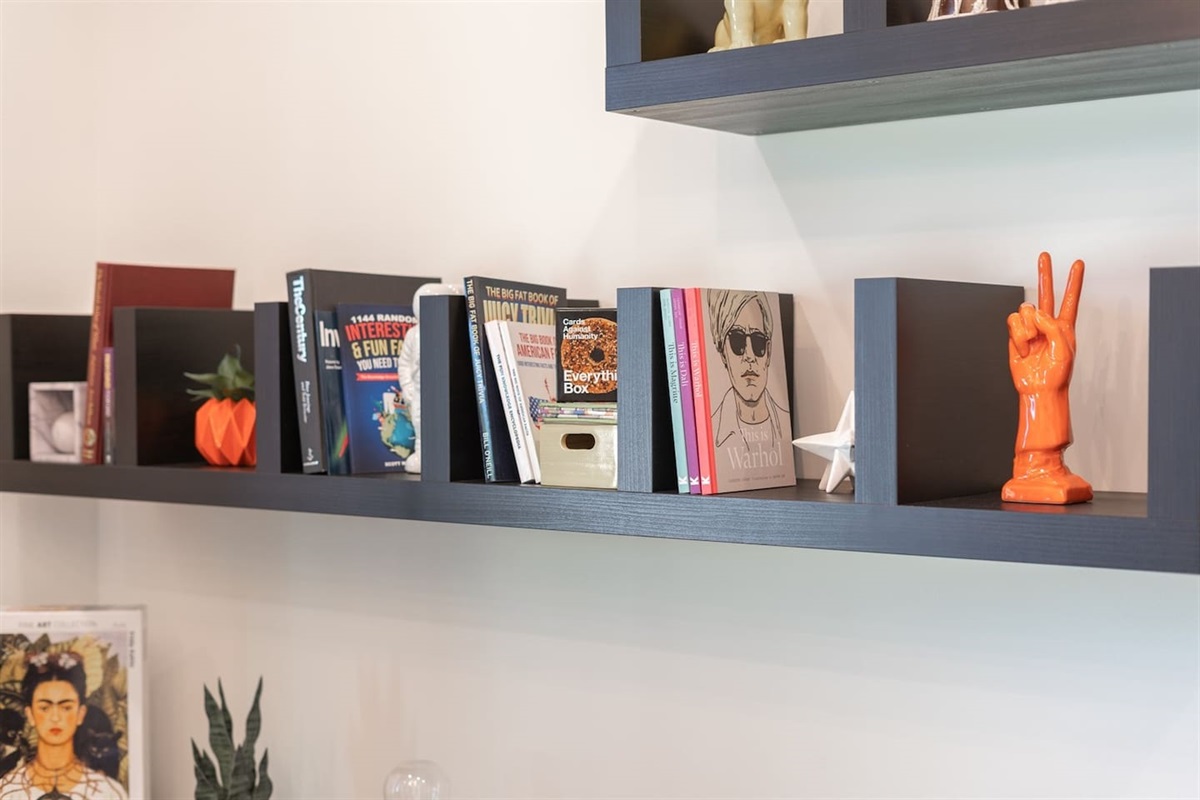 Charming office space with books, decorative plants, and a small painting, creating a cozy and inspiring work environment. Perfect for focused productivity or a quiet escape!  #HomeOffice #AirbnbInspiration