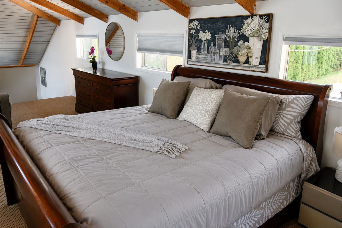 Bedroom 1 King. Comfortable king bed in a bright, peaceful bedroom, offering a relaxing place to unwind after a day at the lake.