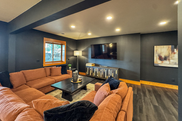Downstairs TV lounge with spacious sectional seating.
