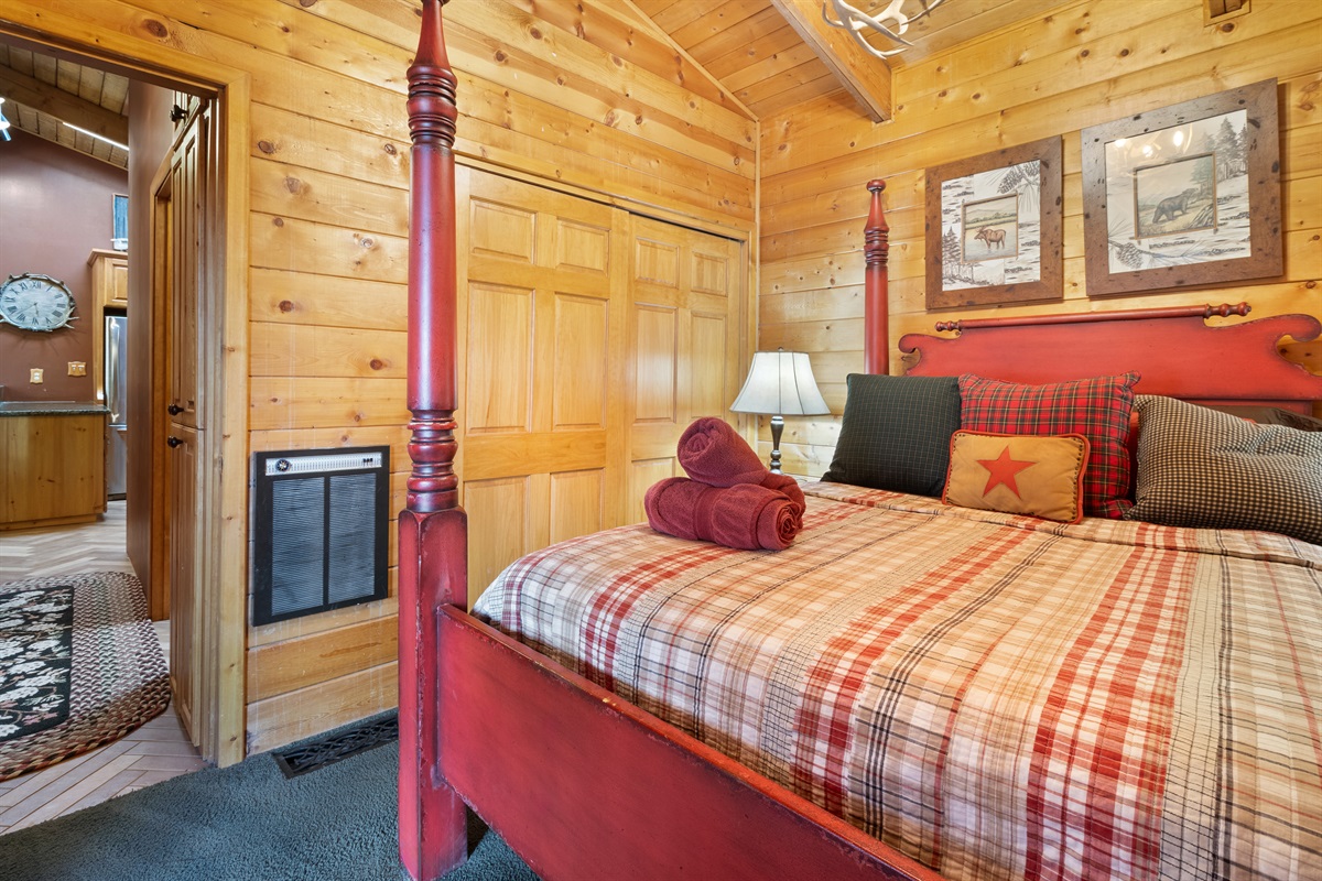 Main bedroom offers cozy poster queen-size bed