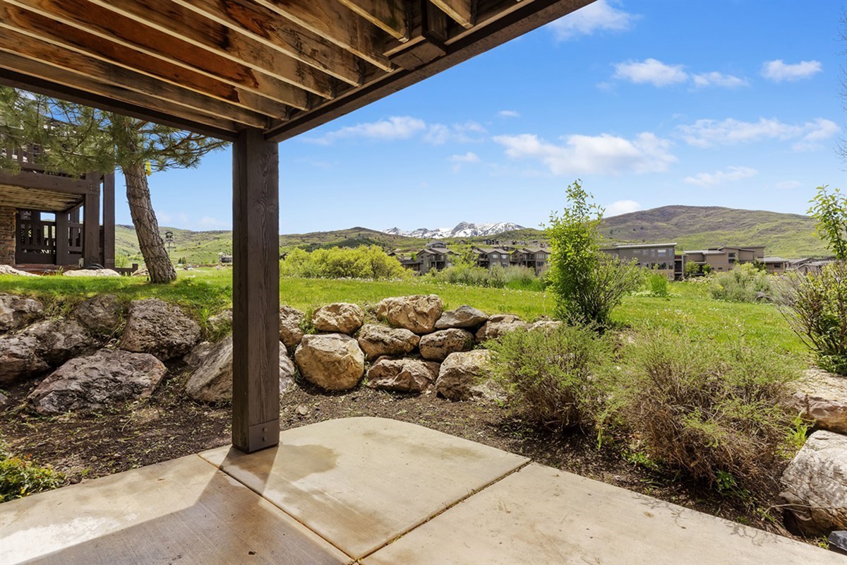 Covered patio with seating—an ideal spot to unwind and enjoy the peaceful mountain setting.
