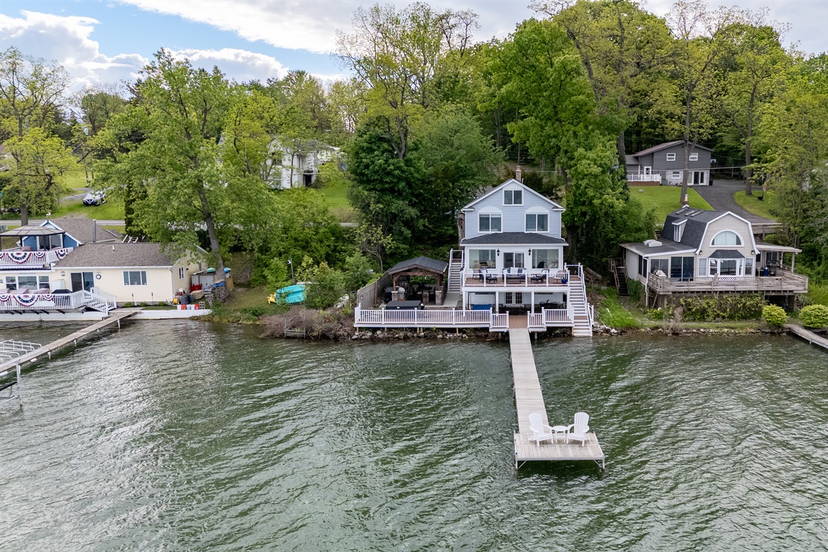 Stunning lakefront home with multi-level decks and a private dock—perfect for sunrise coffees and sunset cocktails 🌅🏡🚤