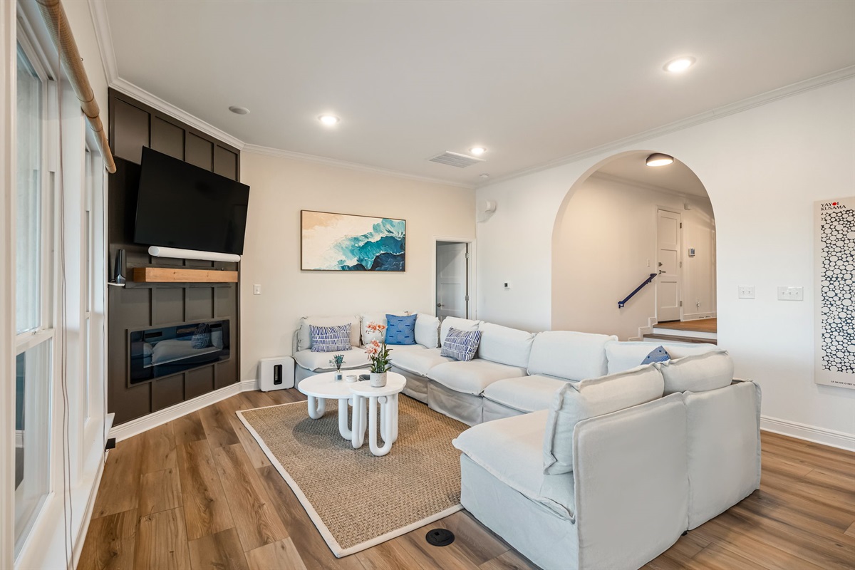 Bright and spacious main living room with plush sectional and open-concept layout — perfect for group gatherings.