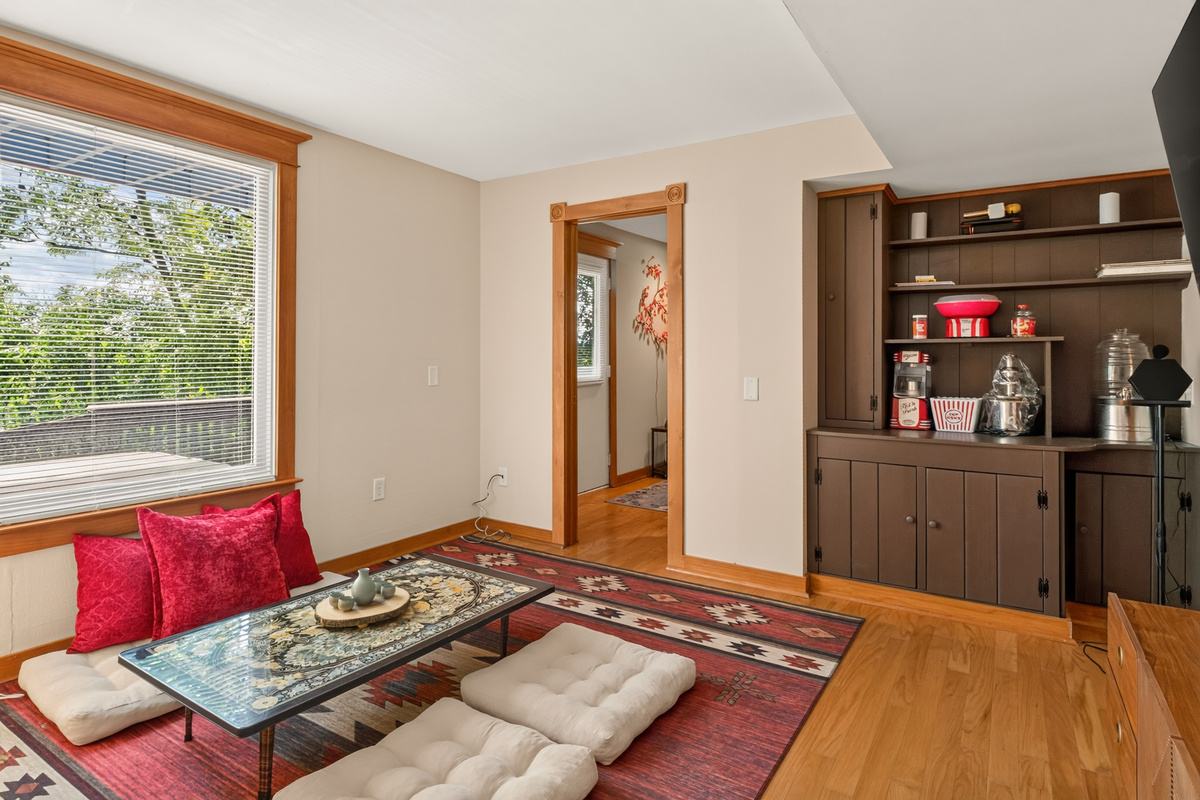 Sitting room with floor cushions and built-in shelving
