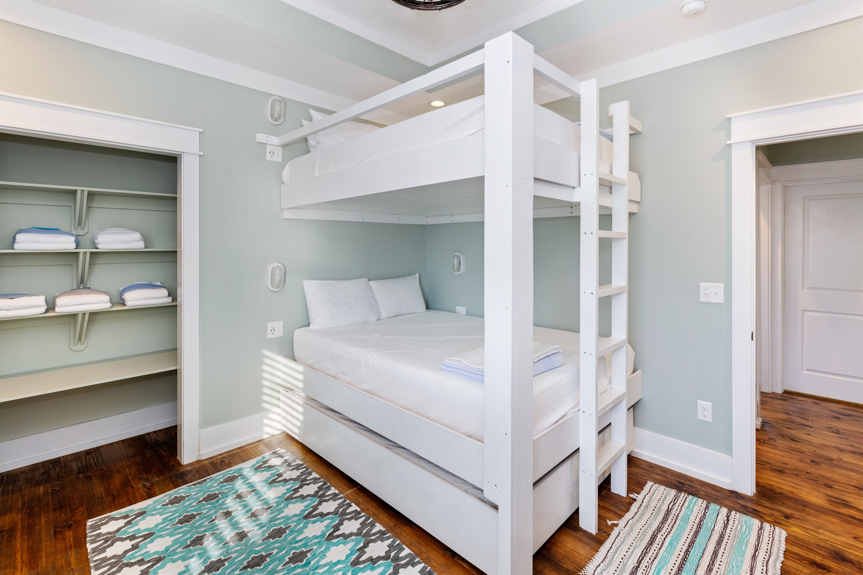 Custom-built, adult-sized queen bunks enable you to sit upright on the upper AND lower bunks. A twin XL trundle bed pulls out from below to offer sleeping accommodations for up to 5 in this third floor bunk room.