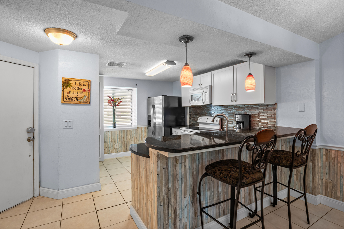 Front entry door. Kitchen bar seating for two people.