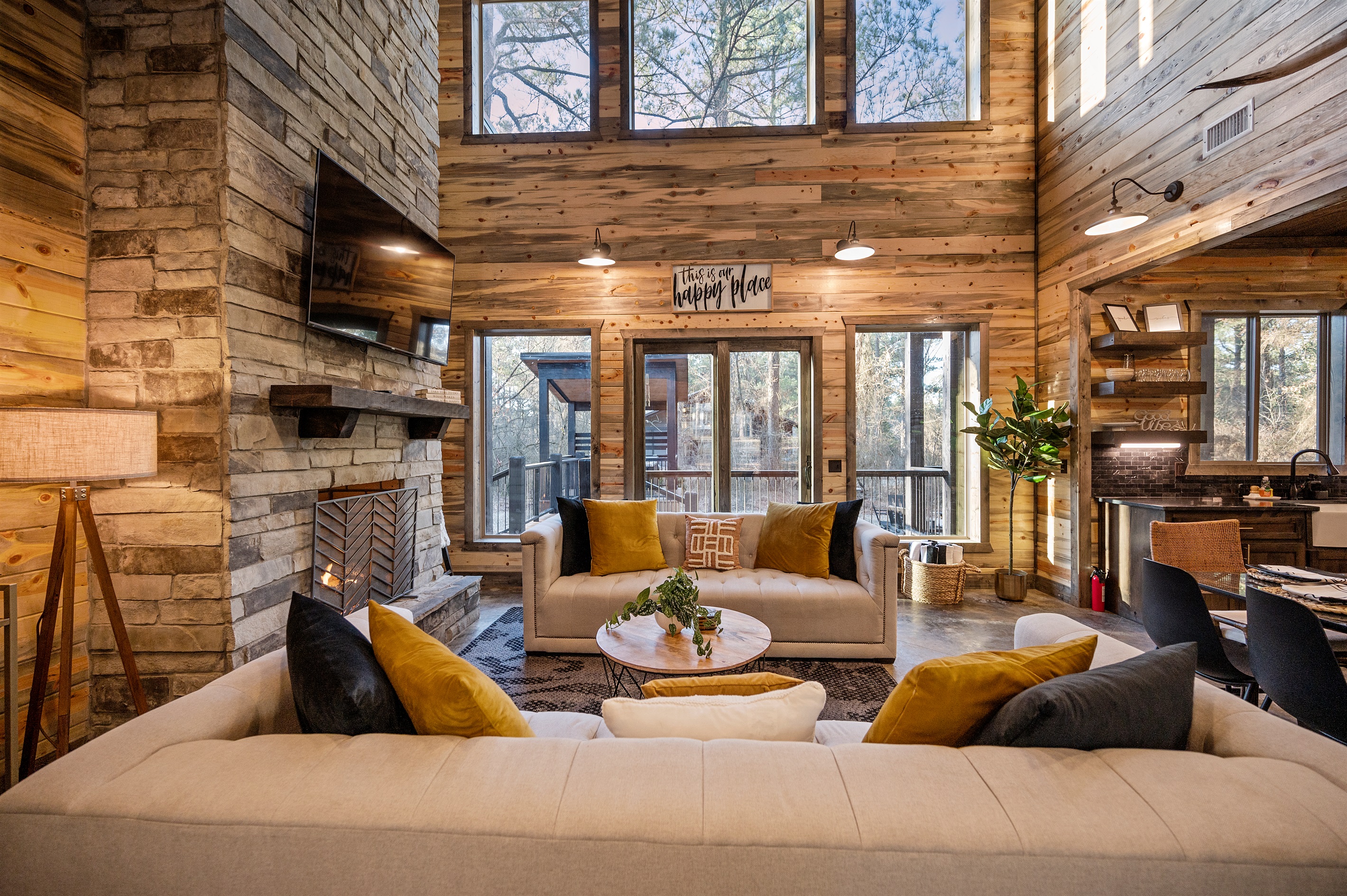 Large windows fill the space with natural light and peaceful forest views.